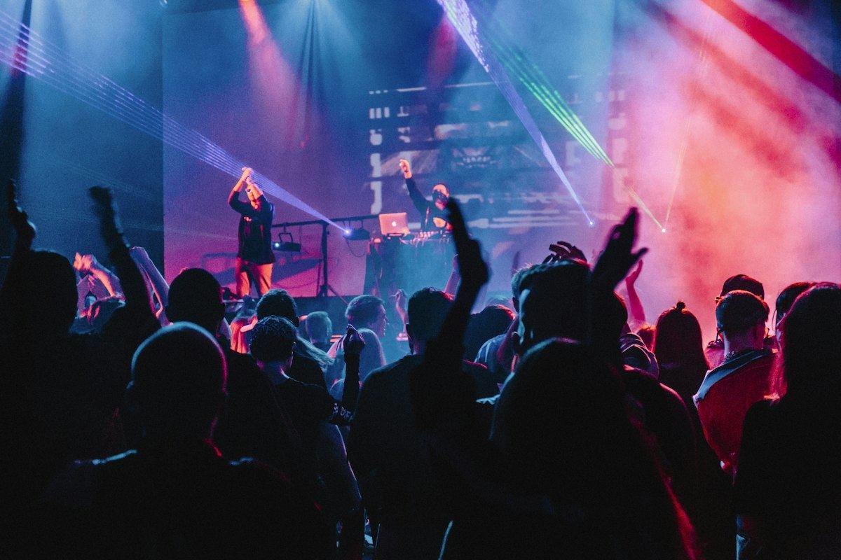 A band on stage under coloured lights